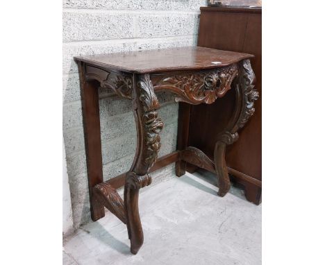 A 19th Century Cromwellian style carved and brass inlaid oak Console Table, the inlaid top with shaped carved frieze on front
