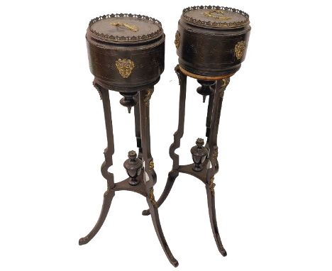 A pair of tall ebonised and brass mounted Jardinieres, each with a cylindrical top with metal liner and circular cover on thr