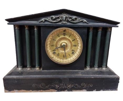 A 19th Century black slate Mantel Clock, the arched top with ornate frieze, the circular brass dial with Roman numerals flank