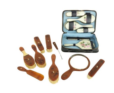 A good cased silver and enamel Vanity Set, comprising hand mirror, four brushes, and a comb, together with another 7 piece fa