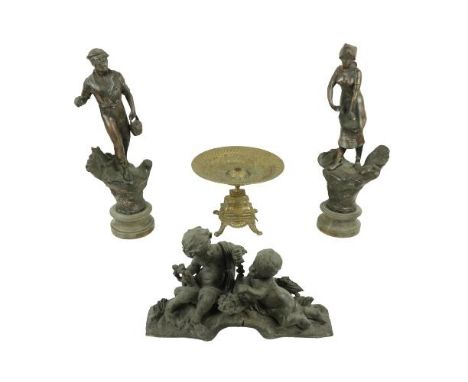A pair of Spelter Figures, 'L'Agriculture' 18'' (46cms), together with a brass Table Centre, on four legs 9'' (23cms) and a S