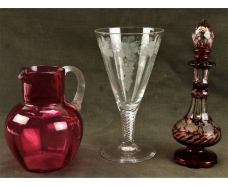 A Bohemian ruby glass and vine engraved Perfume Bottle and stopper, (as is), a cranberry glass Jug and a vine engraved spiral