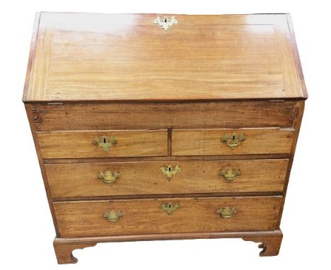 A Georgian mahogany slope front Bureau, the front opening to reveal an arrangement of pigeon hole compartments, drawers, a ce