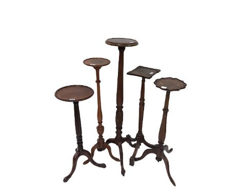 A mahogany Jardiniere or Candle Stand, the square top with projecting corners on a turned and fluted stem and tripod base, 35
