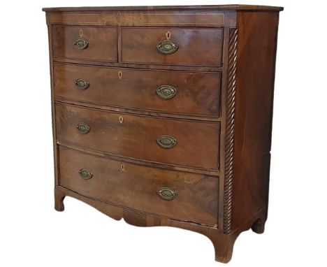 A George IV inlaid and bow fronted mahogany Chest, of three long and two short drawers with 1/4 spiral reeded pilasters on br