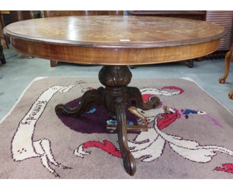 A Victorian style circular pod Dining Table, with floral marquetry top, over plain frieze on carved scroll tripod base, 130cm