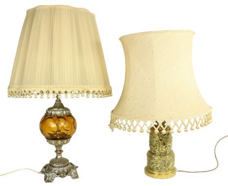 An embossed brass Table Lamp, the two stage body with classical figures in relief supporting an ivory shade, 27'' (69cms); to