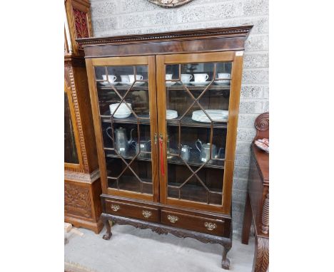 A Chippendale style mahogany Display Cabinet, on associated stand with dentil moulded cornice above two astragal glazed doors