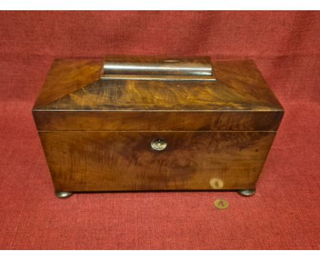 Victorian mahogany flame veneer sarcophagus shaped tea caddy on bun feet.