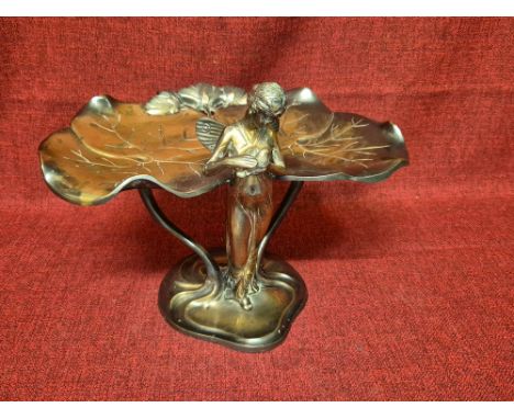 Cast brass WMF style Art Deco dish formed as a Fairy holding a Dove with lily pad leaves, standing 20cm tall.