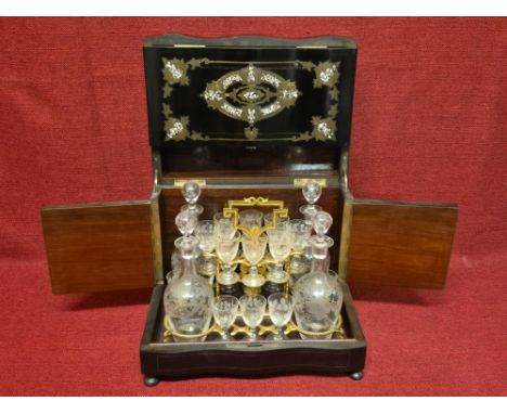 French lacquer liquor Tantalus with fitted gilt metal interior and a full set of 16 glasses and 4 decanters.