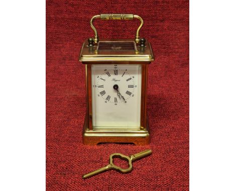 Rapport brass carriage clock with bevel glass panels, Arabic and Roman numeral dial, in good working condition.