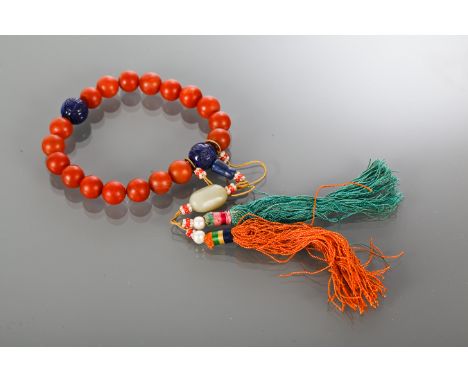 19TH/20TH CENTURY CHINESE RED AGATE BEADS
with lapis lazuli, jade, coral and pearl, and coloured tassles 