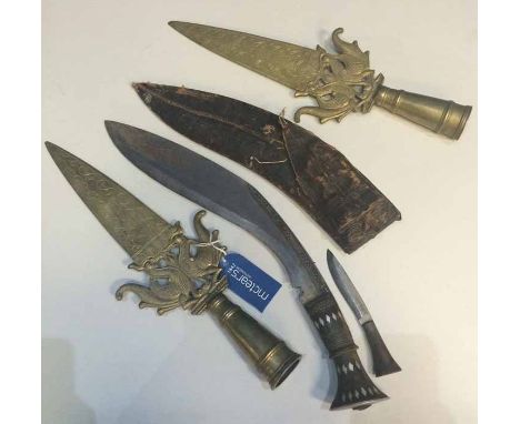 BURMESE GURKHA KUKRI AND TWO BRASS DAGGERS the kukri handle inlaid with white metal, with its leather scabbard; each brass da