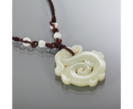 CHINESE JADE AMULET
formed as a stylised coiled dragon, on fabric chain, 5.5cm high 