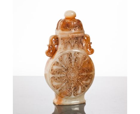 CHINESE WHITE JADE LIDDED VASE
in archaic form, with twin lug handles and stylised floral panel to each side, 21cm high 