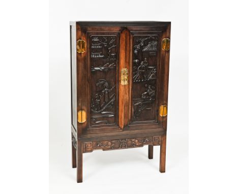 CHINESE HARDWOOD CUPBOARD
the two doors with figural and architectural details in relief, 148.5cm high, 88.5cm wide 