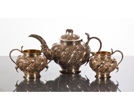 INDIAN SILVER THREE PIECE TEA SERVICE
comprising tea pot, sugar and cream, the tea pot with elephant finial, the sugar and cr