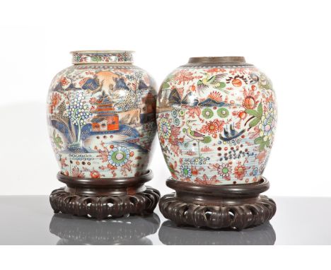 PAIR OF CHINESE GINGER JARS
with floral bird and architectural decoration, each 24cm high, one with lid lacking, each on wood