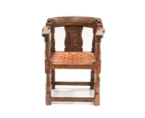 Robert Mouseman Thompson (1876-1955): An English Oak Monks Chair, c1928/9, with curved back and shaped arms, each side carved