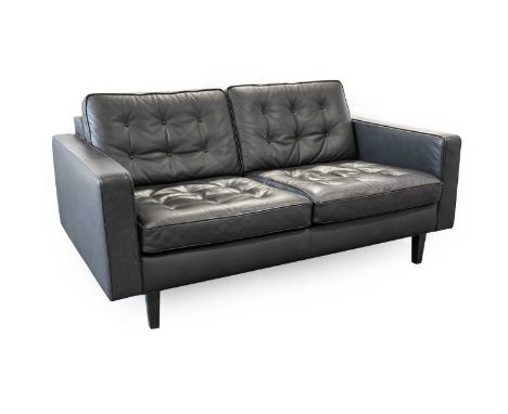 A Hepburn Two Seater Sofa, designed by Paola Navone, button cushion black leather, solid wood frame, black wedge feet, labell