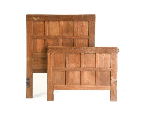 Robert Mouseman Thompson (1876-1955): A Pair of English Oak Panelled 3ft Bedsteads, circa 1930/40s, penny moulded tops, one w