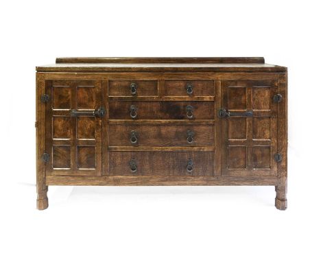 Robert Mouseman Thompson (1876-1955): An English Oak 5' 3" Panelled Sideboard, circa 1930s, with raised upstand above two cup