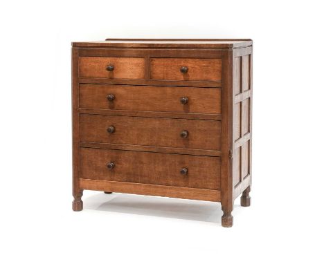 Robert Mouseman Thompson (1876-1955): An English Oak Panelled English Oak Chest of Drawers, with raised upstand above two sho