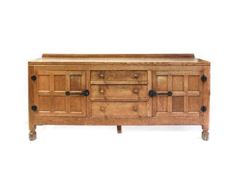 Workshop of Robert Mouseman Thompson (Kilburn): An English Oak 6ft Sideboard, with raised upstand, adzed top over two cupboar