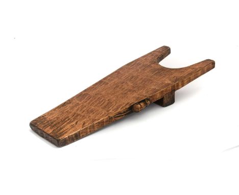 Robert Mouseman Thompson (1876-1955): An English Oak Boot Jack, shaped rectangular design, on a raised block, with carved mou