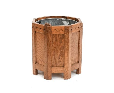 Workshop of Robert Mouseman Thompson (Kilburn): An English Oak Octagonal Planter, contrasting fumed oak panels, with a cylind