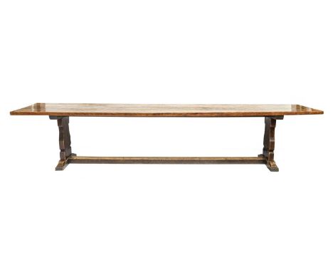 Robert Mouseman Thompson (1876-1955): An English Oak 12ft Refectory Table, the adzed dowelled top, on two shaped supports joi