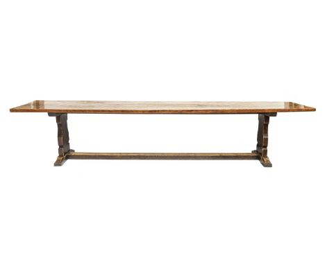 Robert Mouseman Thompson (1876-1955): An English Oak 12ft Refectory Table, the adzed dowelled top, on two shaped supports joi