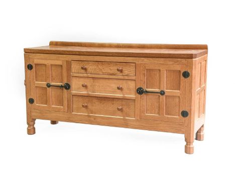 Workshop of Robert Mouseman Thompson (Kilburn): An English Oak 5ft Sideboard, with raised upstand, above two doors enclosing 