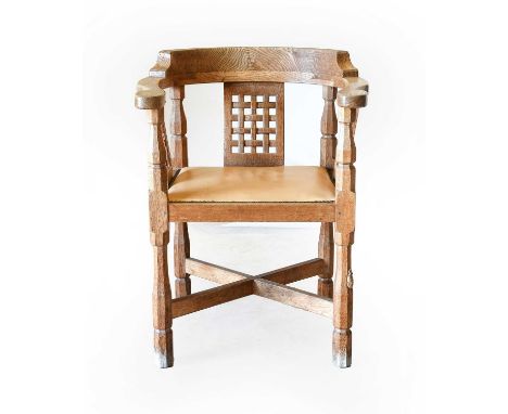 Workshop of Robert Mouseman Thompson (Kilburn): An English Oak Monk's Chair, with curved back and shaped arms, over three lat