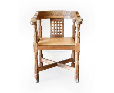 Workshop of Robert Mouseman Thompson (Kilburn): An English Oak Monk's Chair, with curved back and shaped arms, over three lat