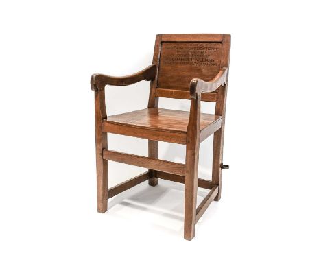 Robert Mouseman Thompson (1876-1955): An English Oak Panel Back Arm Chair, the back with inscription THIS CHAIR WAS PRESENTED