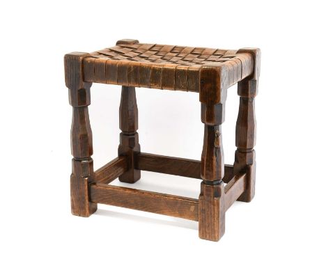 Robert Mouseman Thompson (1876-1955): An English Oak Stool, strap leather top, on four octagonal legs joined by stretchers, w