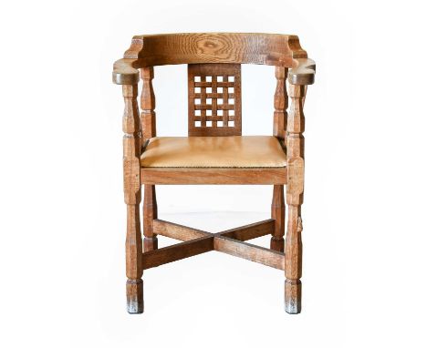 Workshop of Robert Mouseman Thompson (Kilburn): An English Oak Monk's Chair, with curved back and shaped arms, over three lat