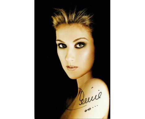 Celine Dion signed 8x6inch colour photo.  Good condition. All autographs come with a Certificate of Authenticity. We combine 