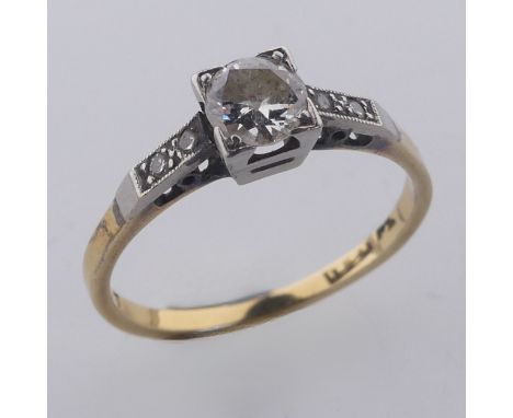 A single stone diamond Ring, the circular stone approx. 0.4ct, in squared mount with two small diamond points on each shoulde