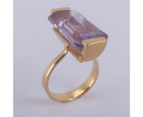 An amethyst Dress Ring, the pale emerald cut stone mounted in 18ct yellow gold, with French marks, 20.5mm long inc. mount, Si