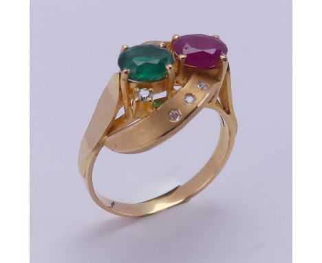 A contemporary ruby and emerald Ring, the oval facetted stones, each approx. 0.7ct, claw set within a scrolling open mount, p