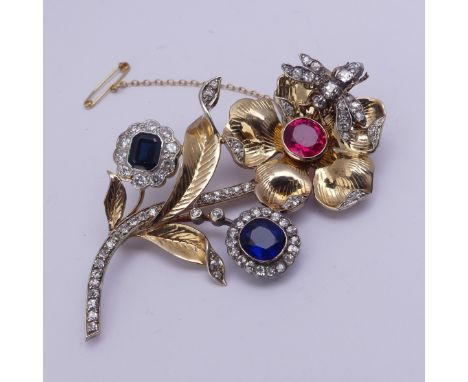 A striking gem set foliate Brooch, formed from other pieces of jewellery including a sapphire and diamond cluster, a blue pas
