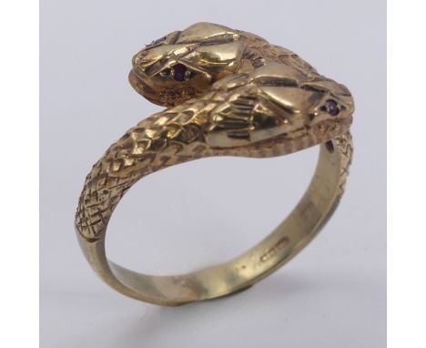 A 9ct yellow gold double snake Ring, with ruby eyes, Birmingham import marks for 1986, Size N, 3.6g. 