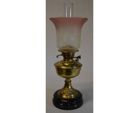 Brass oil lamp with ornate etched glass shade