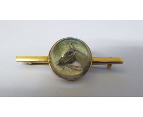 Tested as 15ct gold reverse crystal intaglio stick pin of a horse L 4 cm