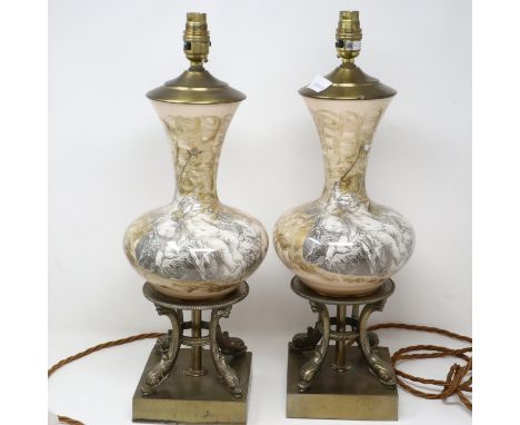 Pair of brass and ceramic lamps featuring cherubs, H: 50 cm. All electrical items in this lot have been PAT tested for safety