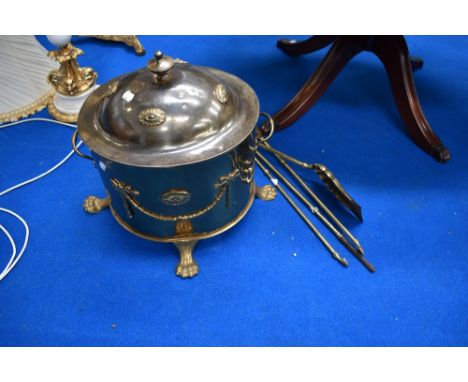 A vintage brass coal bucket and fire tools