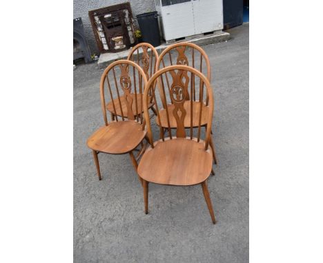 A set of four Ercol hoop and stick chairs with fleur de lys style backs